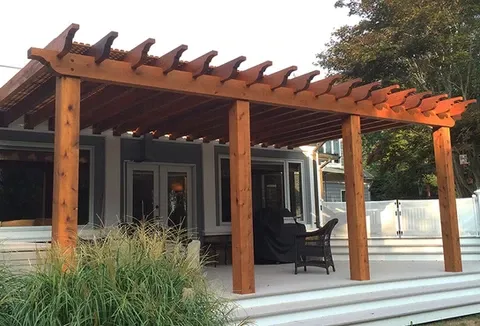 large tan pergola over a back porch