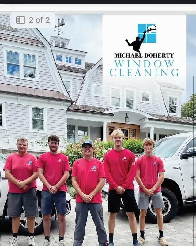Professional window cleaning team in Cape Cod posing in front of completed project