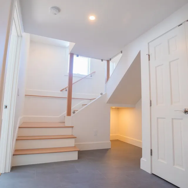Finished basement stair and landing with tile floor