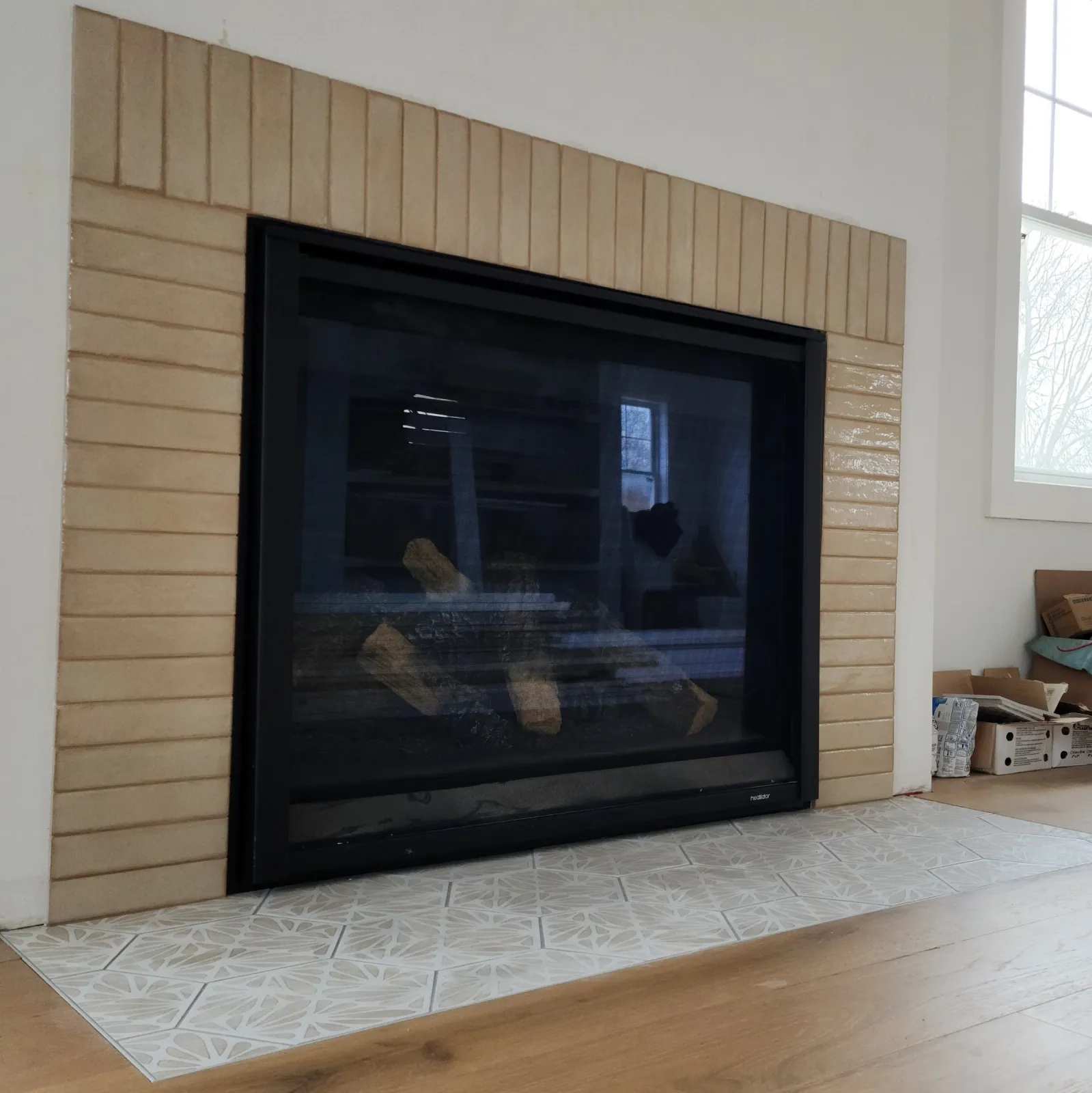 Fireplace framed with vertically stacked tile and a tiled hearth