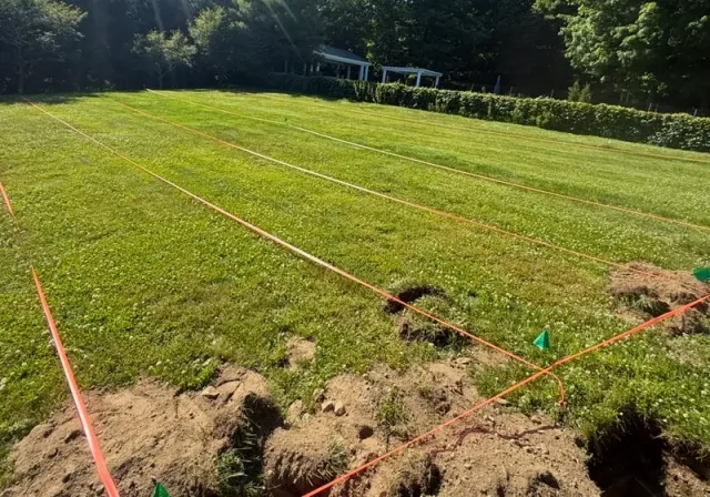 Septic drain field layout measured and marked with string lines and flags