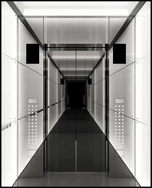 A photograph depicting the interior of a modern, reflective elevator cab. The walls of the cab are highly polished, creating a mirror-like effect that adds depth and a futuristic feel to the space. On either side of the elevator, there are sleek push button panels, featuring an array of buttons for various floors. These panels are neatly arranged and illuminated, providing easy accessibility and a contemporary look. The reflective surfaces and the well-designed control panels combine to give the elevator a sophisticated and high-tech ambiance.