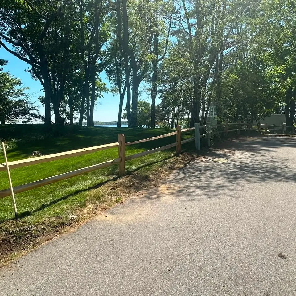 Cedar split-rail fence along a coastal property drive
