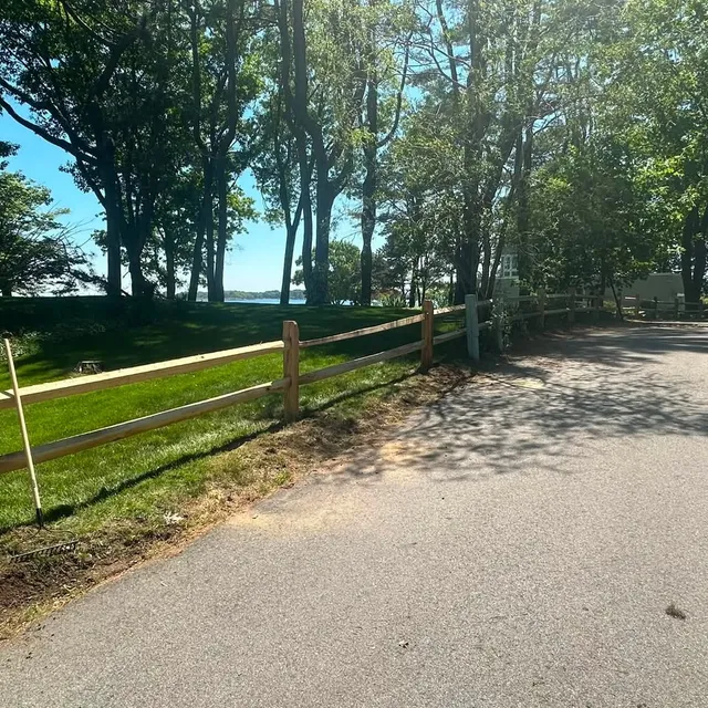 Cedar split-rail fence along a coastal property drive