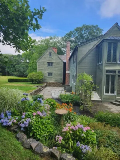 A house with a garden in front of it on a sunny day.