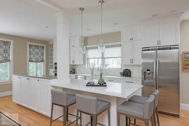 Classic white Scituate kitchen with Mouser cabinetry, Calacatta Rome quartz, and a contrasting island