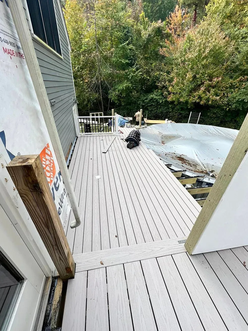A deck is being built on the side of a house