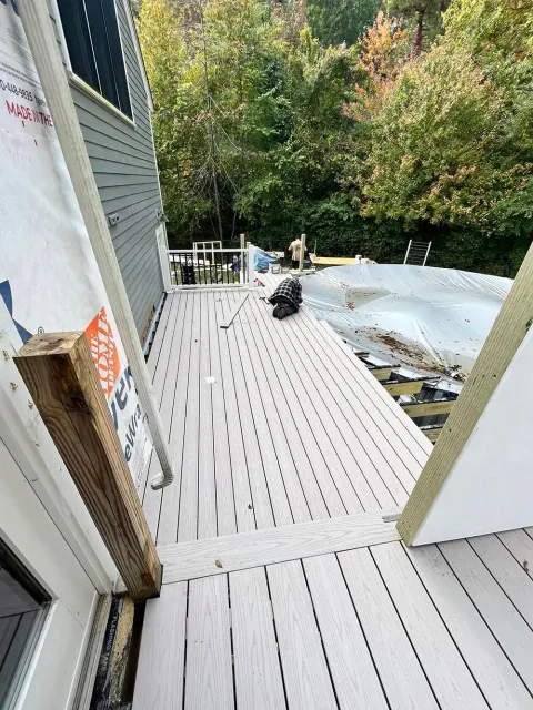 A deck is being built on the side of a house