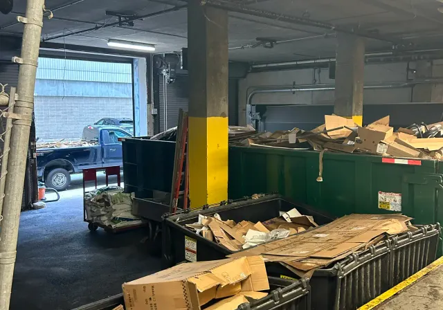 Debris area with bins for junk removal by FreshStart Home Services in Rhode Island, showcasing eco-friendly practices.
