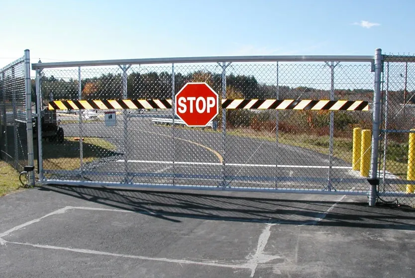 Cantilever chain link security gate at a facility entrance