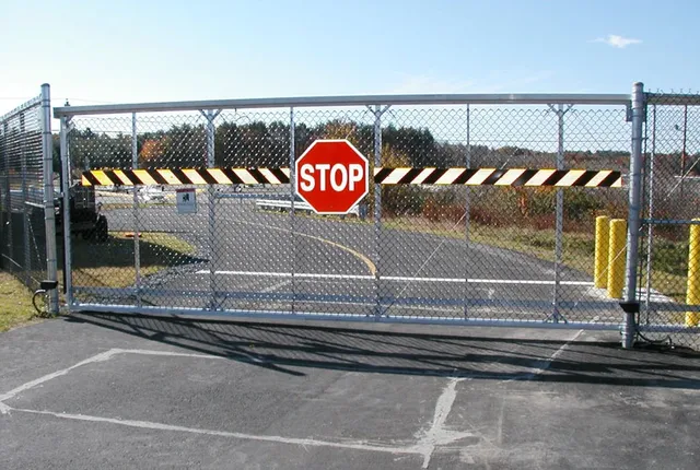 Cantilever chain link security gate at a facility entrance