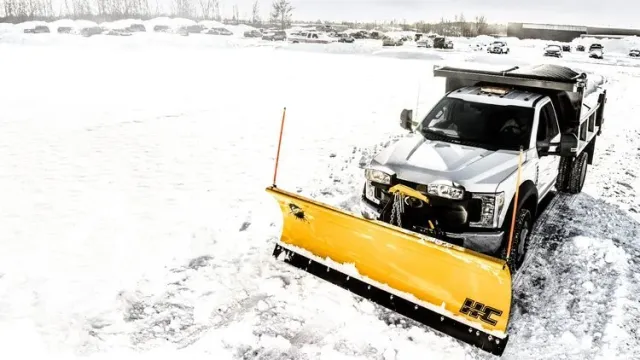 Artisan Grounds crew clearing snow with a plow truck during a commercial snow removal service on the New Hampshire Seacoast.