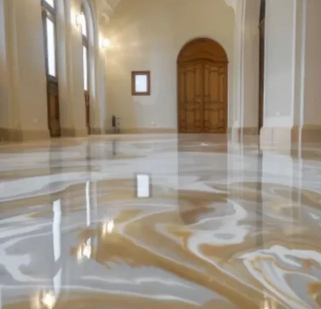 Interior of a spacious room with shiny marble floors and high ceilings, featuring an arched doorway and large windows.
