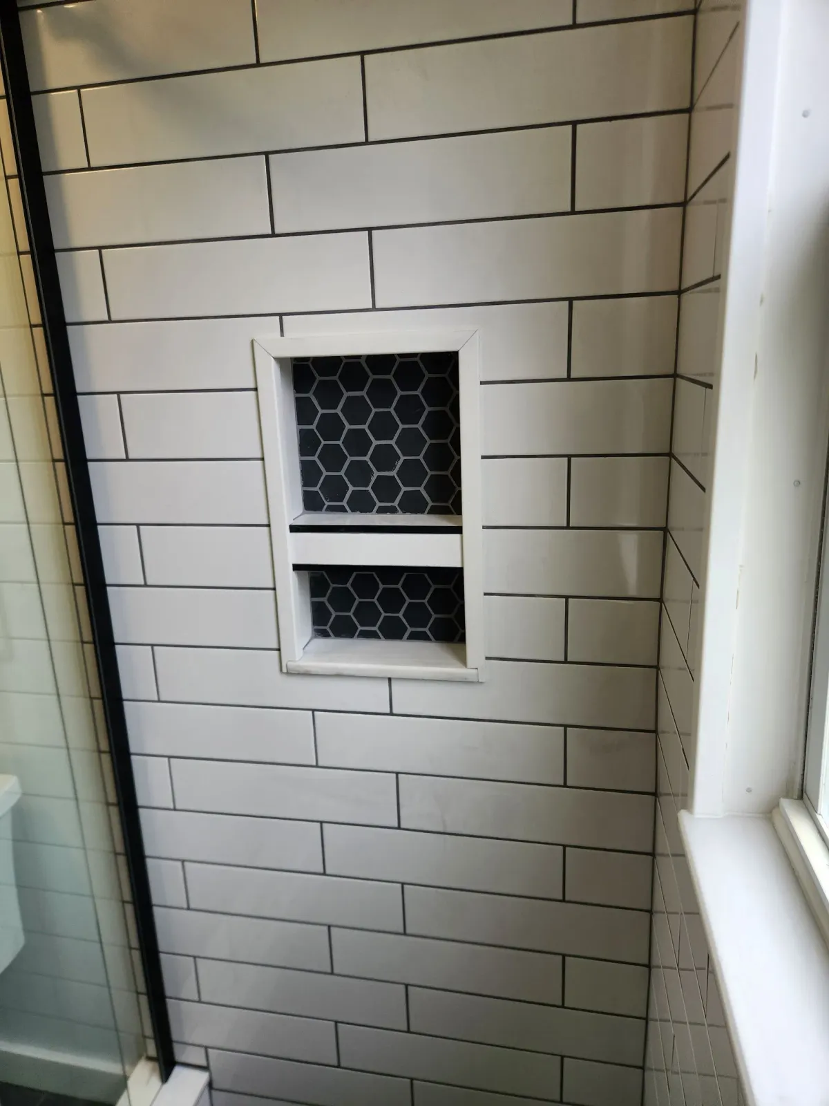 A bathroom with a tiled floor and a door.