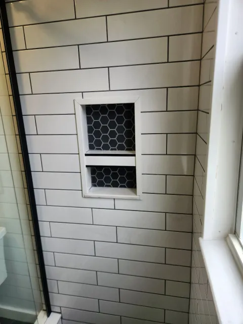 A bathroom with a tiled floor and a door.
