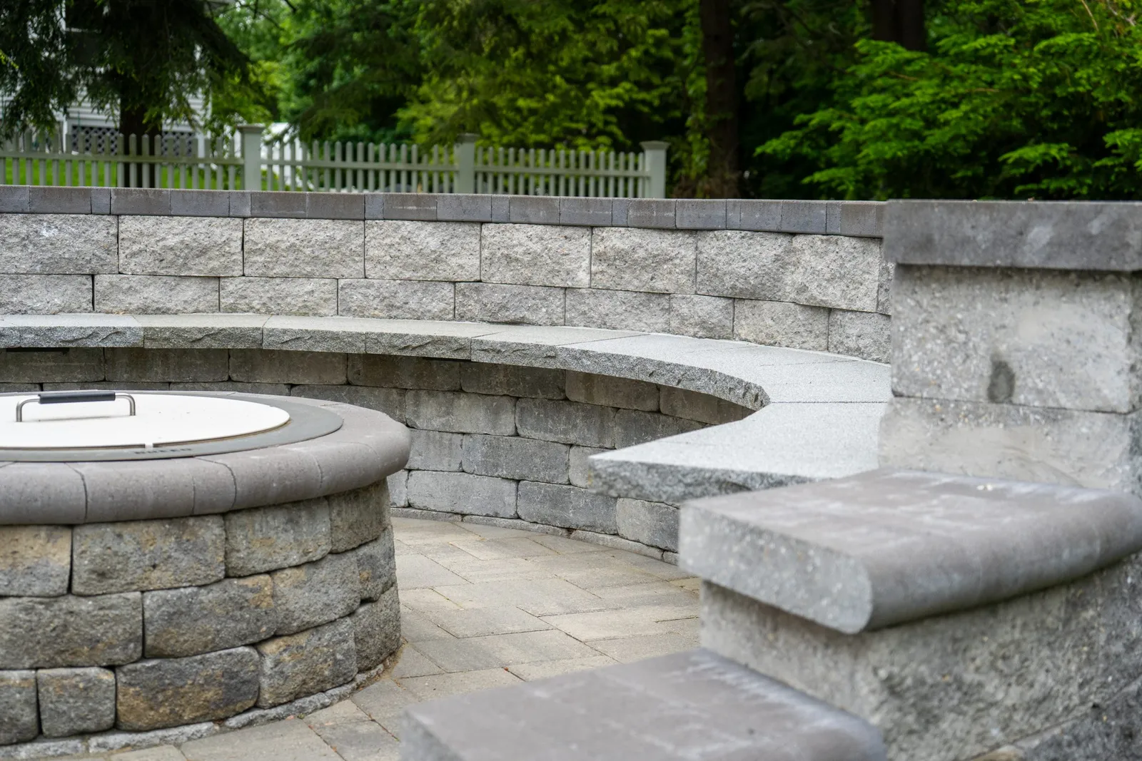 Stone patio with curved seating and fire pit