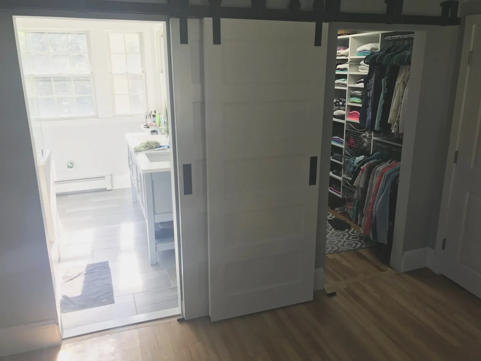 Bypass barn doors in front of a master bath that was split into a master bath and closet.