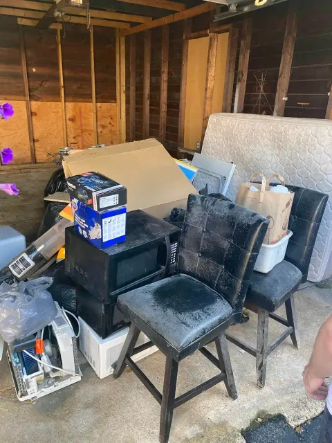 Cluttered garage pile awaiting pickup by professional junk hauling services.