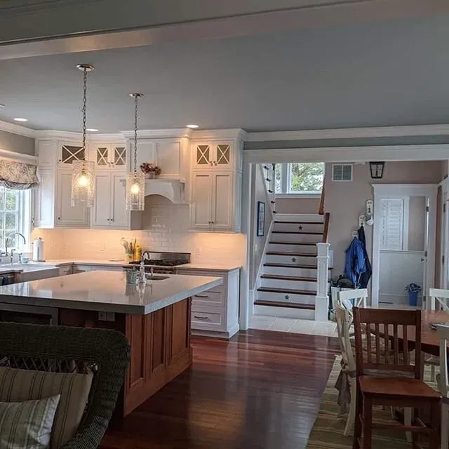 Even during these challenging times, our team is still working hard.  Check out one of our recently completed kitchens, a mix of classic white cabinetry, backsplash &amp; countertop contrasted by rich, beautiful hardwood floors and a large center isl