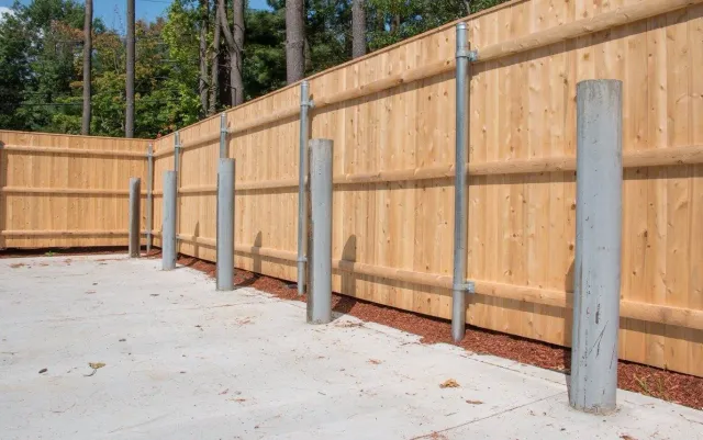 Wood to steel dumpster enclosure