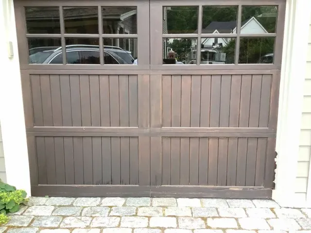 A garage door with a car parked inside of it
