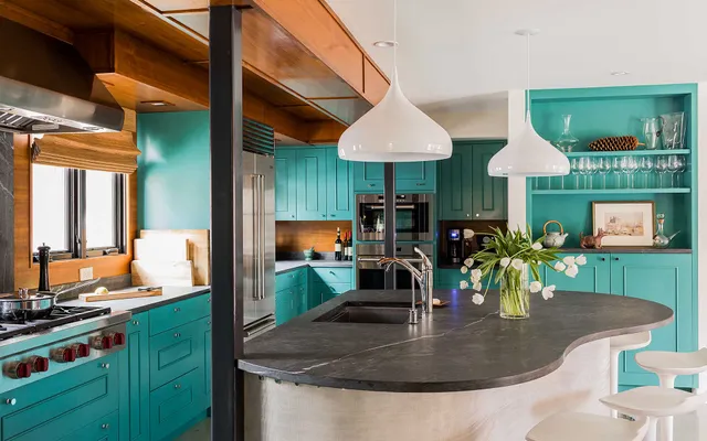 A kitchen with blue cabinets and a counter top