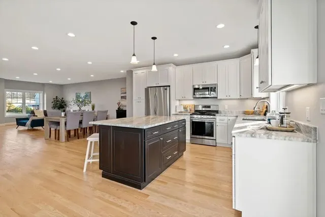 Kitchen island with granite countertops and pendant lighting in Wakefield, MA