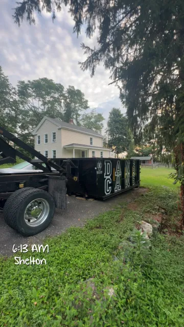 Roll-off dumpster placed safely on a driveway in a CT neighborhood
