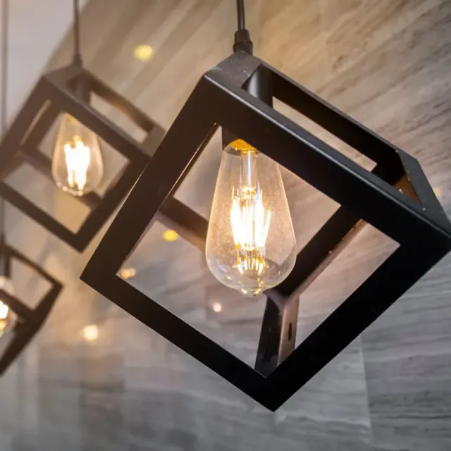 A row of square pendant lights hanging from the ceiling