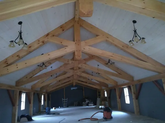 a large room with a vaulted ceiling and wooden beams