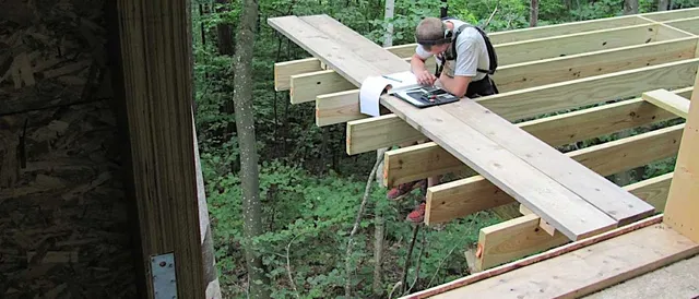 contractor making plans at small building company construction site