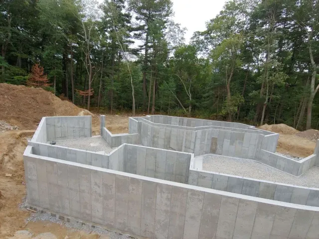 A concrete foundation is being built in the middle of a forest.