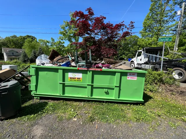 Dumpster loaded with junk and debris