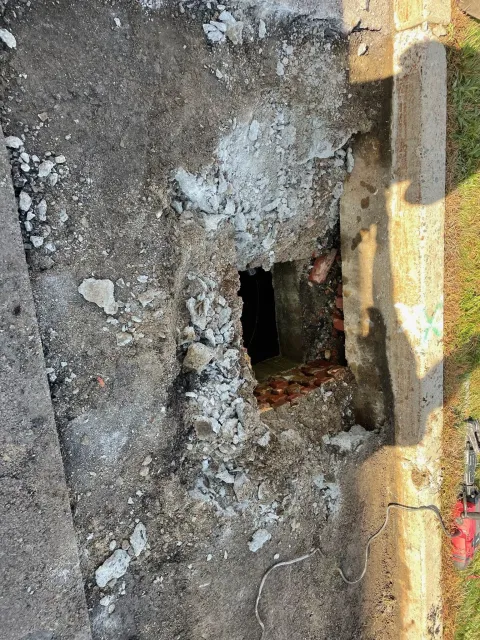 There is a hole in the ground in the middle of the road.