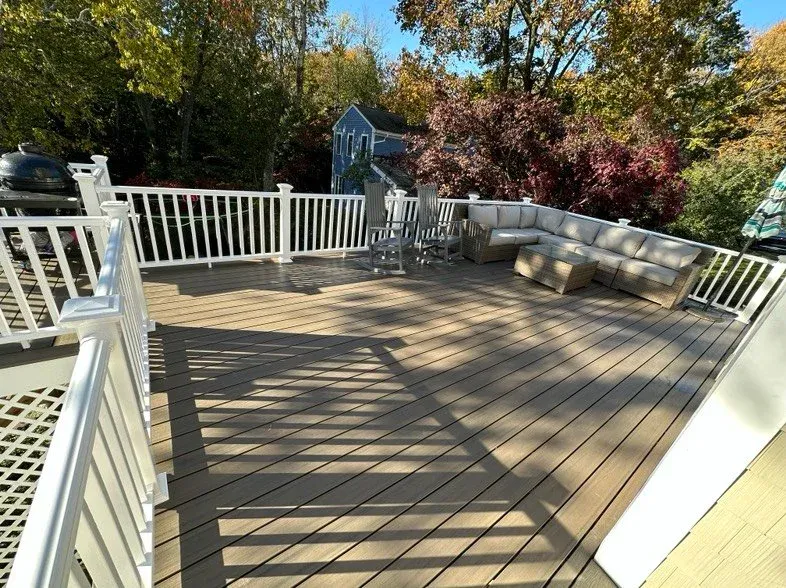 Custom composite deck installation in Scituate, MA with PVC trim and professional carpentry by New Age Home Improvement LLC.