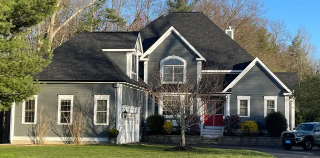 Old vinyl siding removal before replacement in Needham, MA"