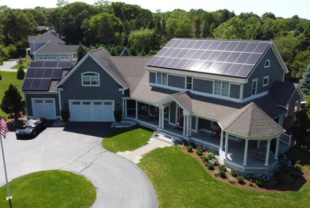 Residential home with solar panels and EV charger, showcasing rooftop solar installation.