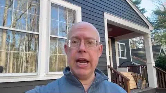 Person speaking outside a finished house in a Target Painting video