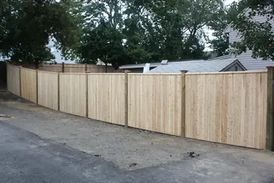 Cedar privacy fence run along a driveway
