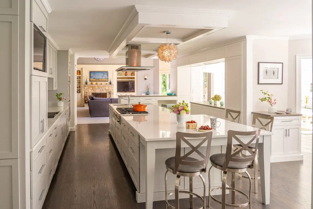 Spacious kitchen remodel with a large island, white cabinetry, and an open-concept design in Acton, MA, by Thomas Buckborough & Associates