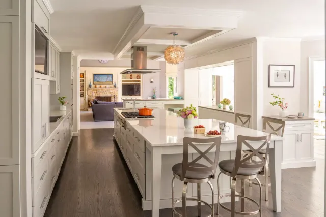 Spacious kitchen remodel with a large island, white cabinetry, and an open-concept design in Acton, MA, by Thomas Buckborough & Associates
