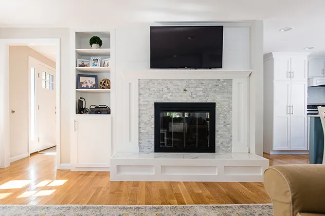Custom built-in shelving and fireplace mantle millwork by 1731 Woodworks
