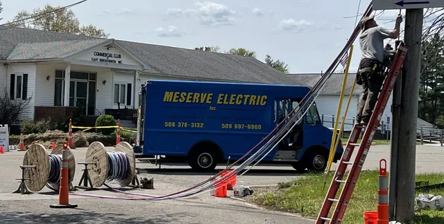 Electric utility truck at residential job site for electrical repair work