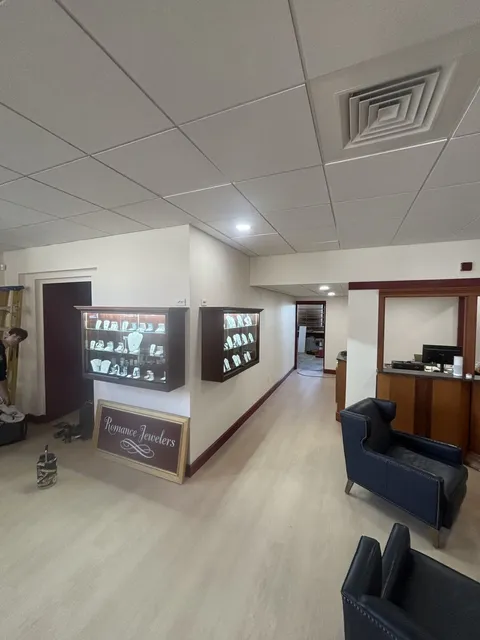Lit wall display cases and lounge chairs in the finished jewelry store