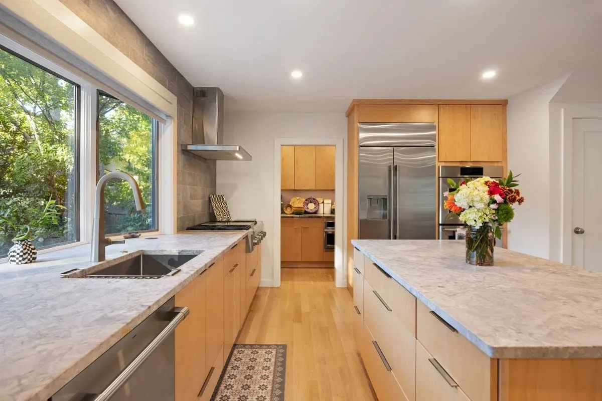 Functional kitchen layout with large island and natural light by PEGASUS Design-to-Build in Melrose, MA kitchen and addition renovation-optimized