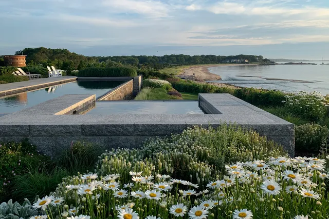 Granite-walled pool and spa overlooking a tidal beach