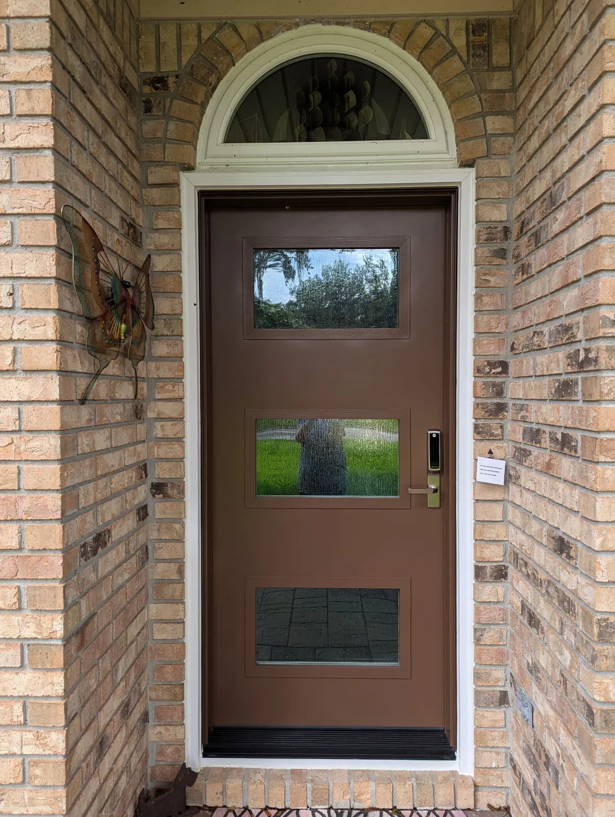 A renovated entry door on a brick house
