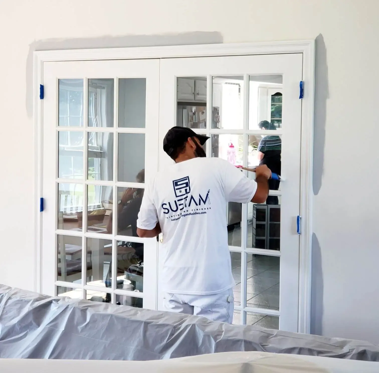 suetam paing team member painting an interior of a home