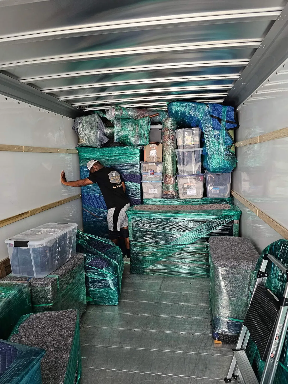 image of a humanitarian aid fundraising event, with volunteers stacking boxes in a modern yet welcoming space