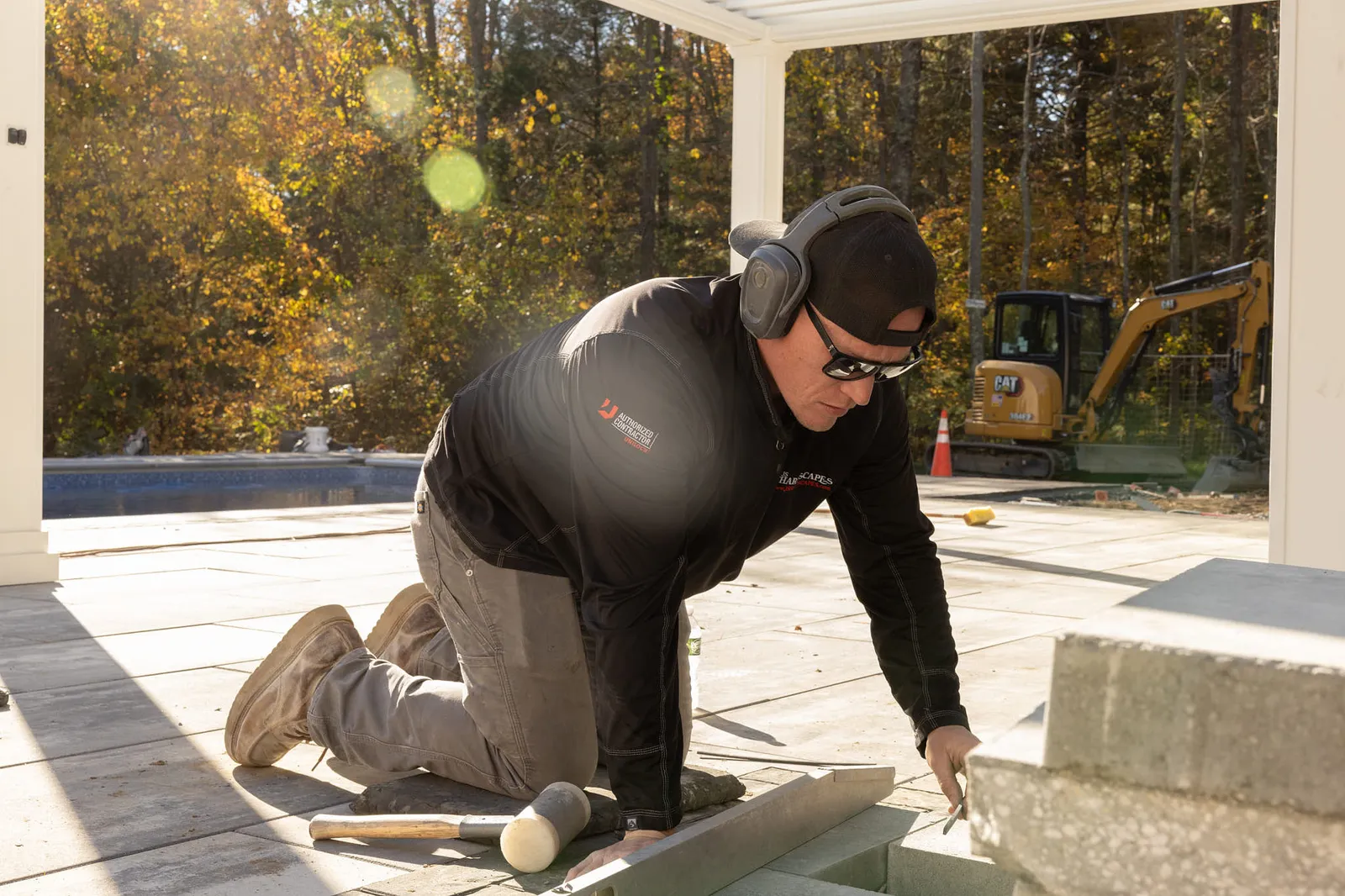 JS Hardscapes team working on paver patio and stone steps.